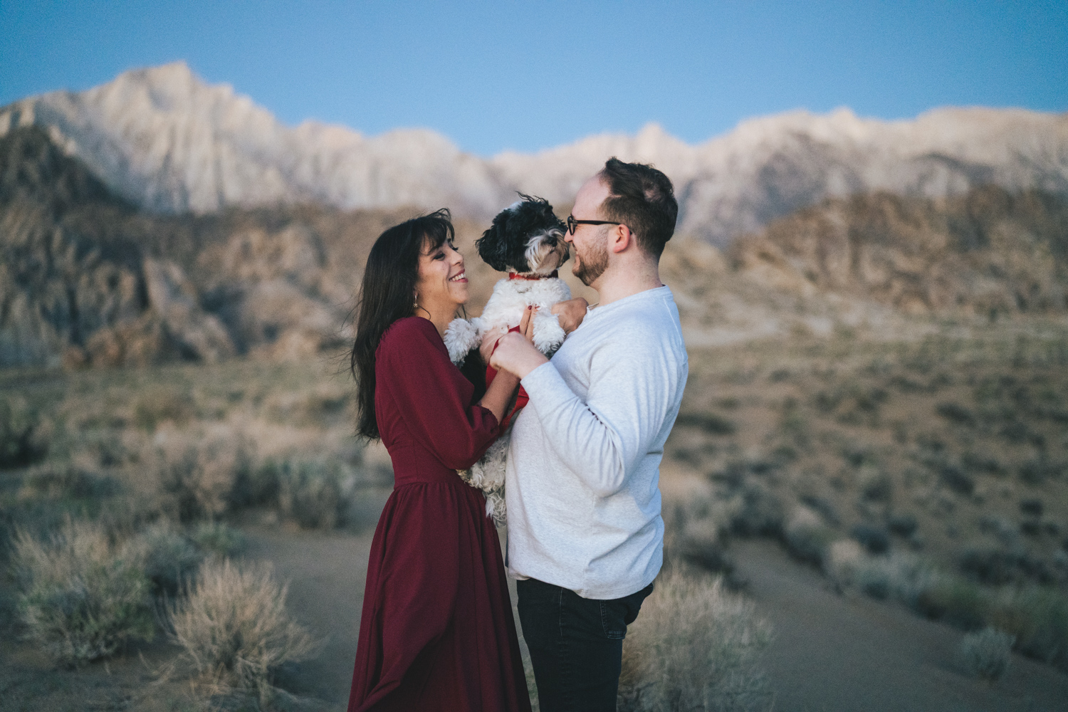 Engaged couple holds puppy in the Alabama Hills