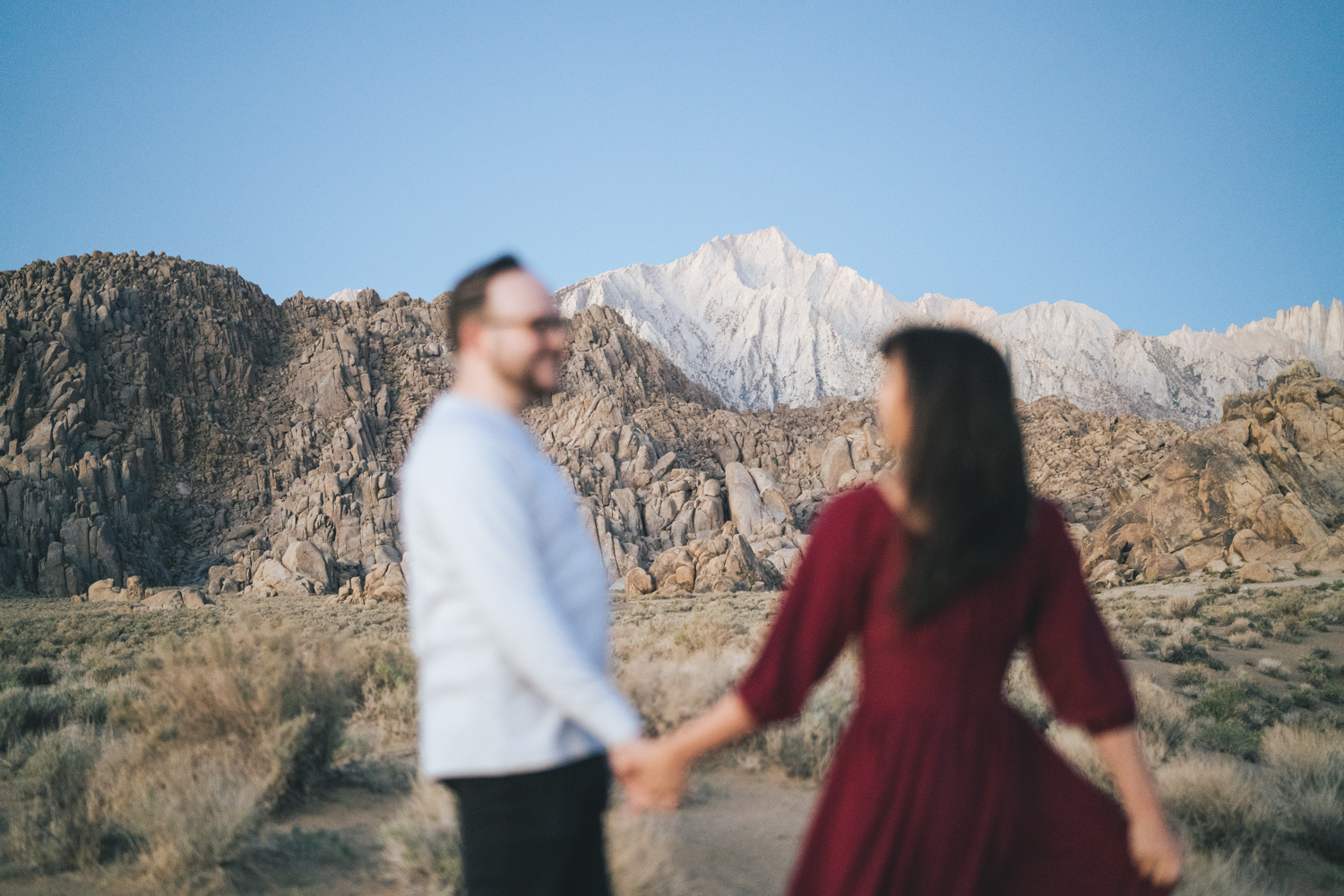 Engaged couple holds hands in the Alabama Hills