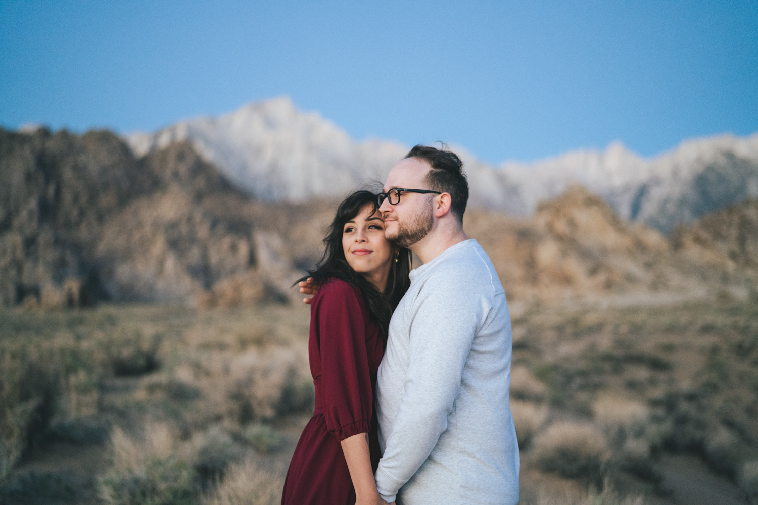 Engaged couple wearing a red dress in the Alabama Hills