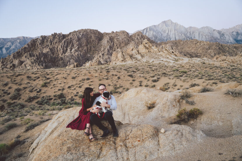 Engaged couple holding puppy in the Alabama Hills