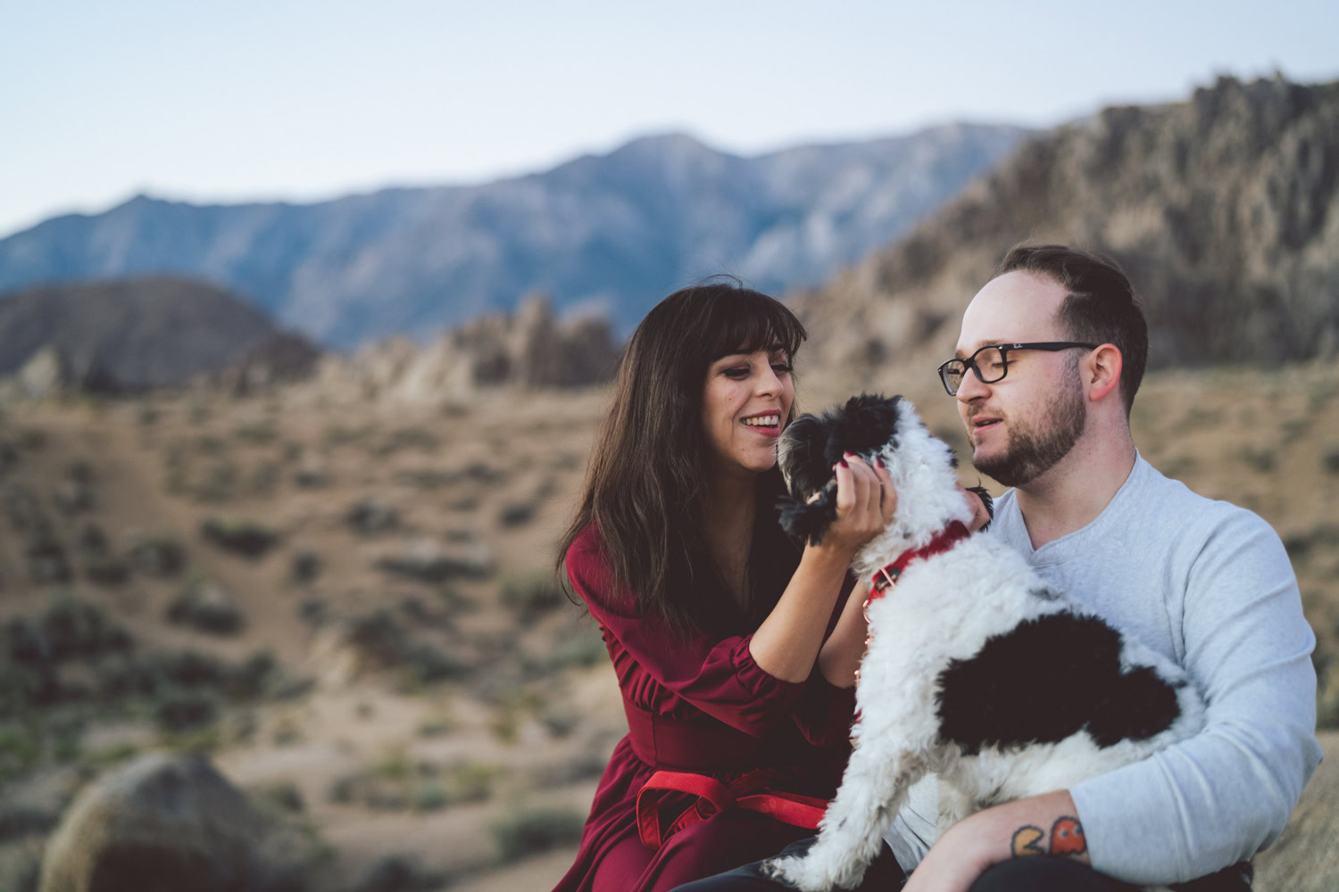 Engaged couple holding puppy in the Alabama Hills