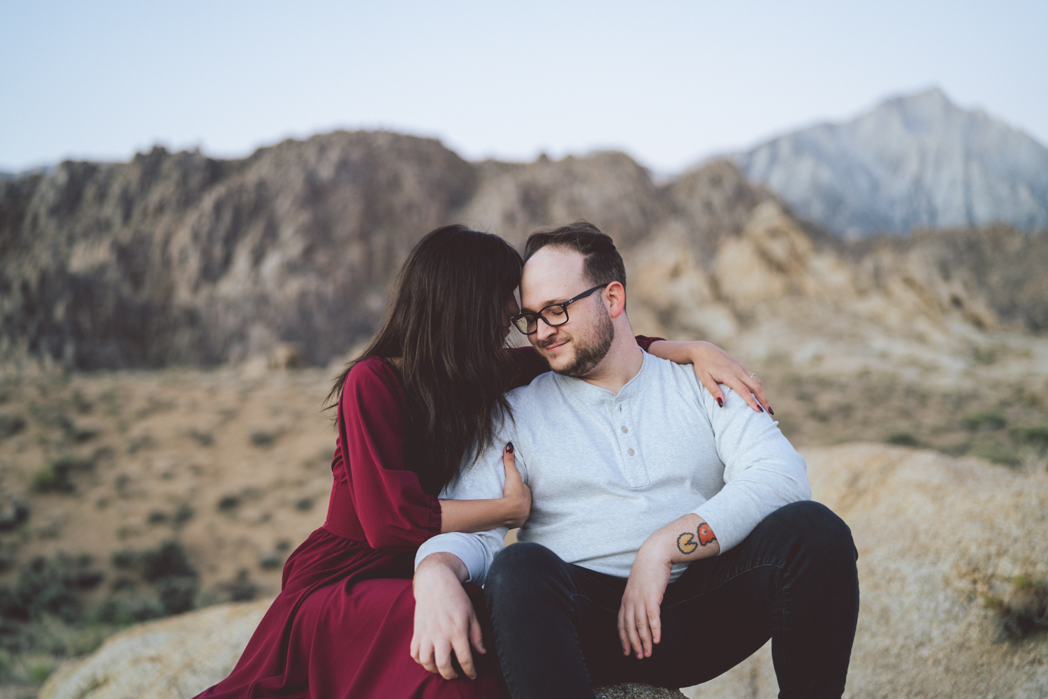 Engaged couple cuddling in the Alabama Hills