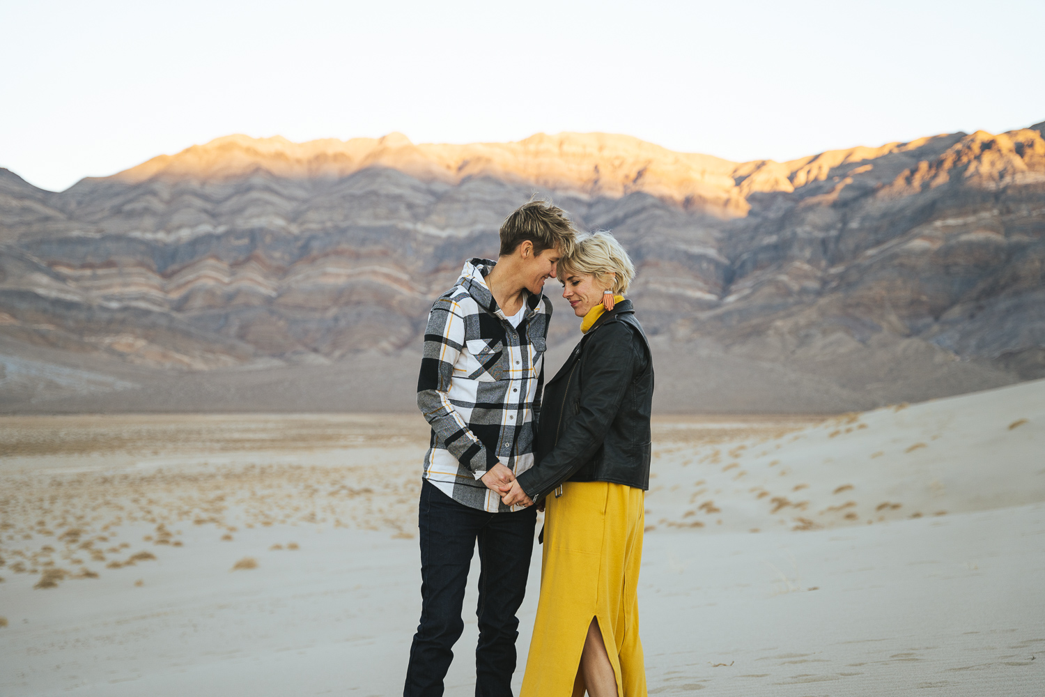 Two brides in the Death Valley Sand dunes, wearing a casual yellow dress