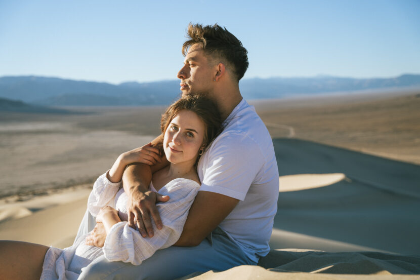 Engaged couple wearing white in the Eureka Sand Dunes