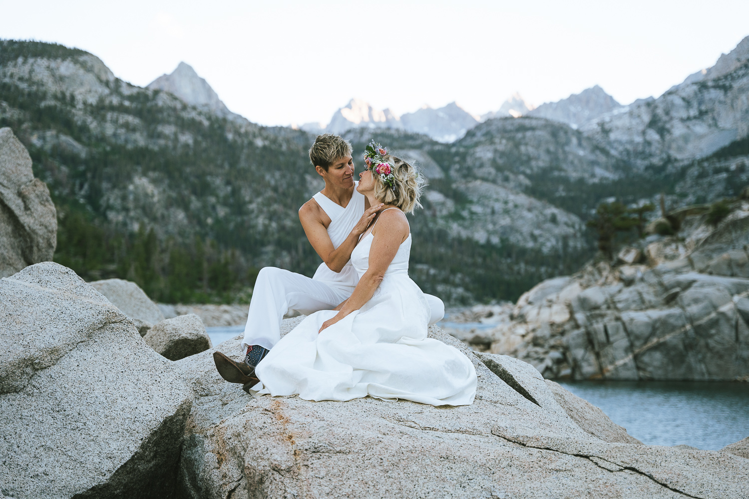 two brides sitting at lake sabrina